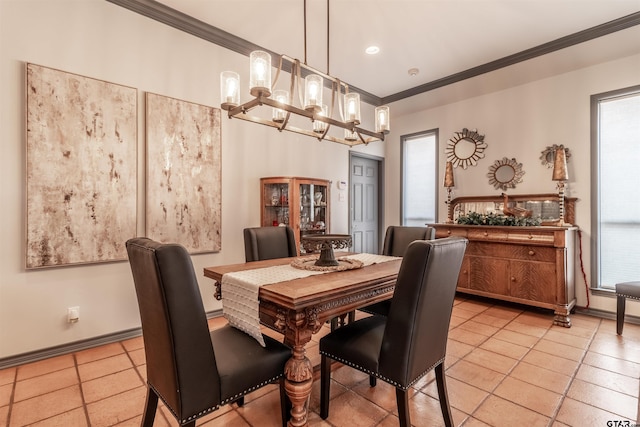 tiled dining space with crown molding and a chandelier