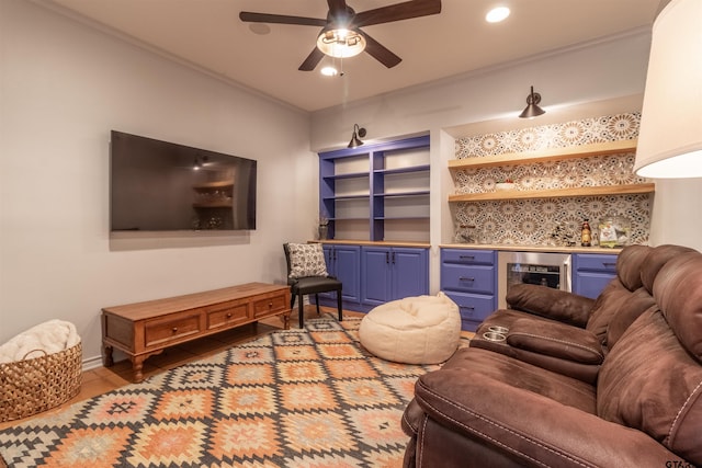 living room featuring ornamental molding, wine cooler, and bar area