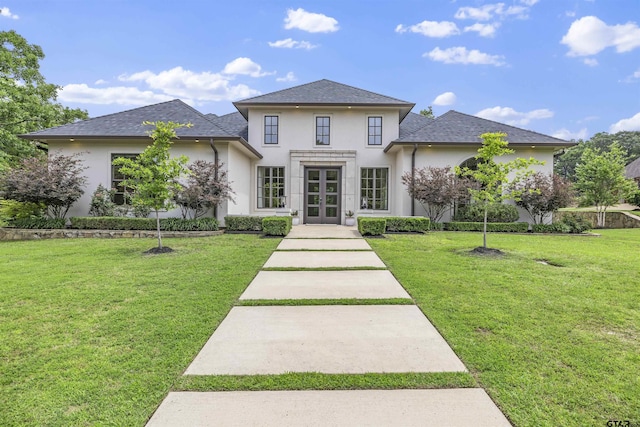 4645 Cascades Blvd, Tyler, TX 75709 - view of front of home featuring french doors, stucco siding, a front yard, and a shingled roof