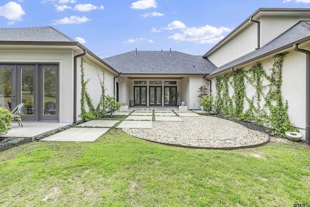 4645 Cascades Blvd, Tyler, TX 75709 - rear view of house featuring french doors, stucco siding, a yard, a patio area, and a shingled roof