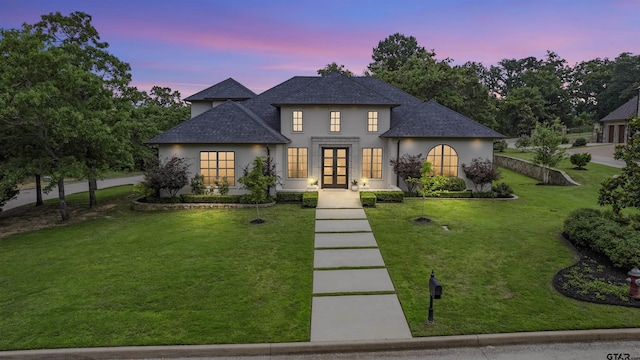 4645 Cascades Blvd, Tyler, TX 75709 - view of front facade with french doors, stucco siding, a front lawn, and a shingled roof