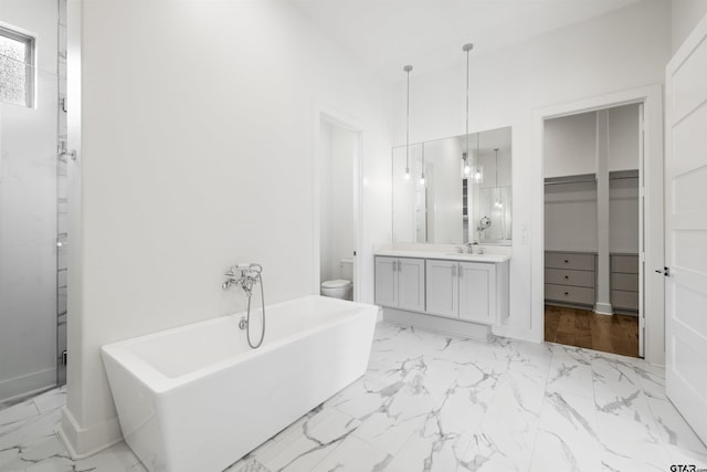 4645 Cascades Blvd, Tyler, TX 75709 - bathroom with toilet, marble finish flooring, vanity, a freestanding tub, and a shower stall