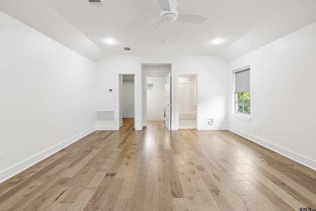 4645 Cascades Blvd, Tyler, TX 75709 - unfurnished bedroom with vaulted ceiling, light wood finished floors, a walk in closet, a ceiling fan, and baseboards