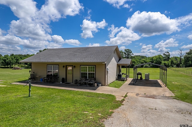 13094 Fm 2010, Chandler, TX 75758 - view of front facade featuring asphalt driveway, a detached carport, a shingled roof, and a front lawn