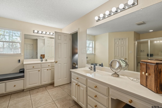 13094 Fm 2010, Chandler, TX 75758 - full bath with a textured ceiling, a shower stall, vanity, and tile patterned floors