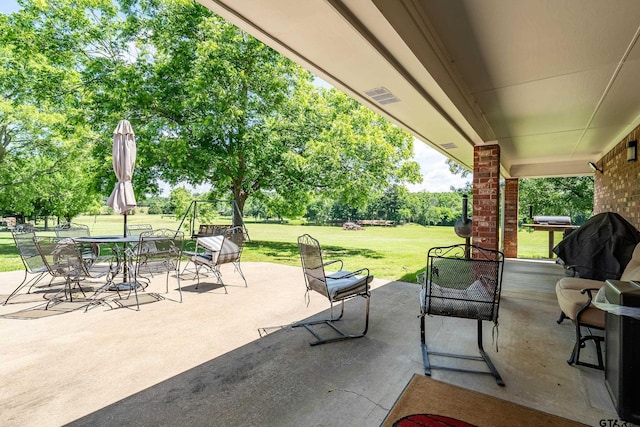 13094 Fm 2010, Chandler, TX 75758 - view of patio with outdoor dining space and view of wooded area