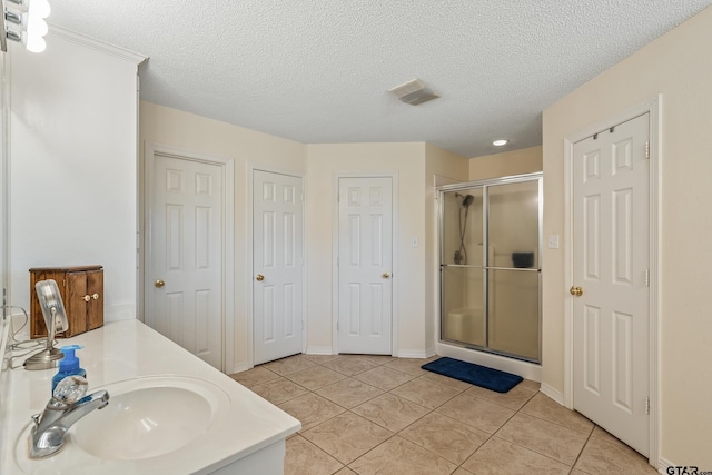 13094 Fm 2010, Chandler, TX 75758 - bathroom with a shower stall, a textured ceiling, tile patterned flooring, vanity, and baseboards