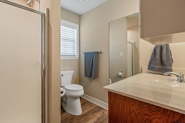 13094 Fm 2010, Chandler, TX 75758 - bathroom with wood finished floors, baseboards, toilet, vanity, and a shower with shower door