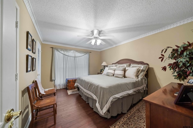 bedroom with a textured ceiling, dark hardwood / wood-style floors, ceiling fan, and crown molding