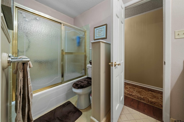 bathroom with shower / bath combination with glass door, toilet, a textured ceiling, and hardwood / wood-style flooring