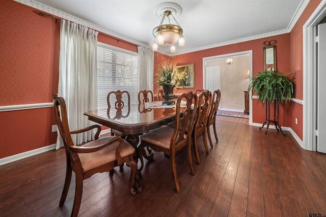 dining area with dark hardwood / wood-style flooring, ornamental molding, and a textured ceiling