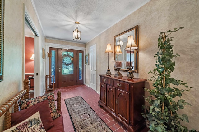 foyer entrance with crown molding and a textured ceiling