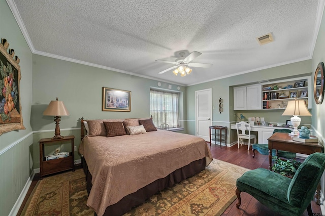 bedroom featuring a textured ceiling, ceiling fan, dark hardwood / wood-style flooring, and crown molding