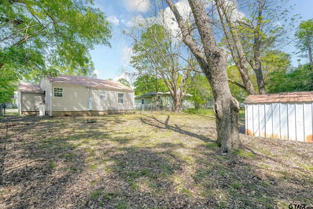 616 Arizona Ave, Wake Village, TX 75501 - view of yard featuring a shed, fence, and an outdoor structure