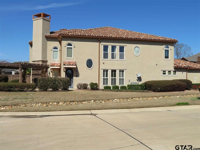 954 La Vista Dr, Tyler, TX 75703 - rear view of house featuring a chimney, a tiled roof, stucco siding, and a pergola