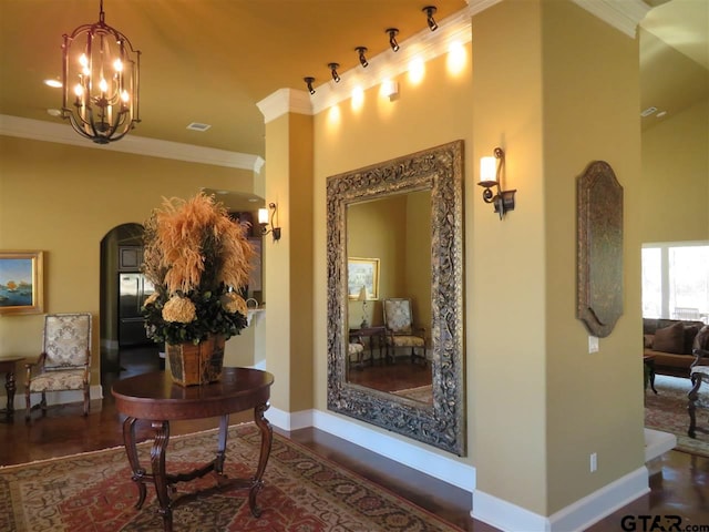 954 La Vista Dr, Tyler, TX 75703 - hall featuring arched walkways, crown molding, baseboards, a chandelier, and wood finished floors