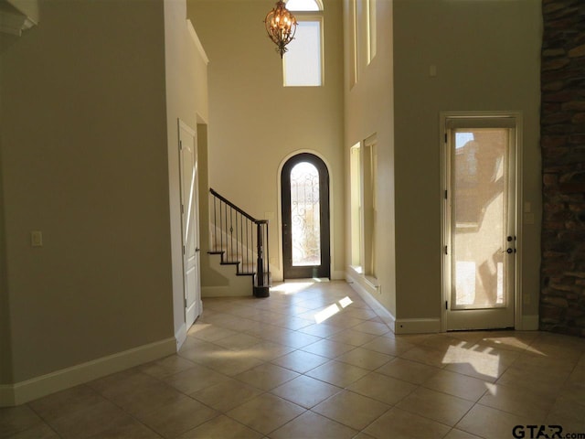 954 La Vista Dr, Tyler, TX 75703 - foyer with healthy amount of natural light, a high ceiling, stairway, and tile patterned flooring