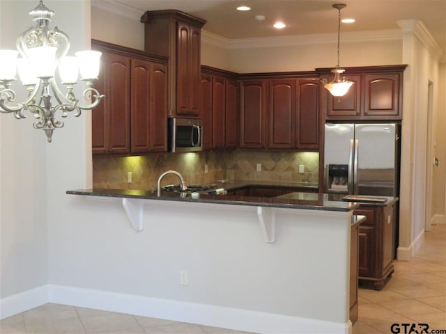 954 La Vista Dr, Tyler, TX 75703 - kitchen featuring appliances with stainless steel finishes, a peninsula, tasteful backsplash, a chandelier, and recessed lighting