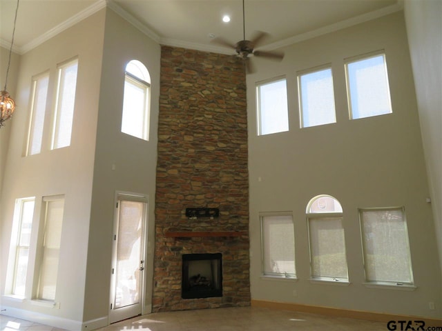 954 La Vista Dr, Tyler, TX 75703 - unfurnished living room featuring a high ceiling, a ceiling fan, baseboards, a fireplace, and ornamental molding