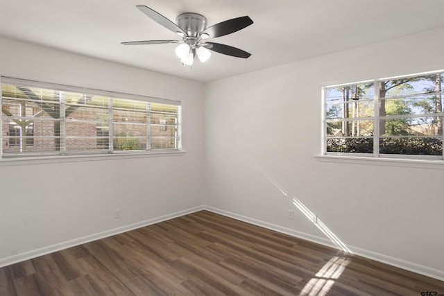 empty room featuring dark wood-type flooring, ceiling fan, and baseboards