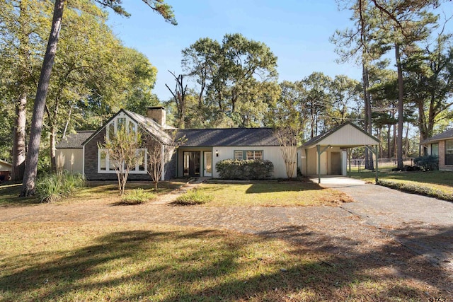 single story home featuring a front lawn and a carport