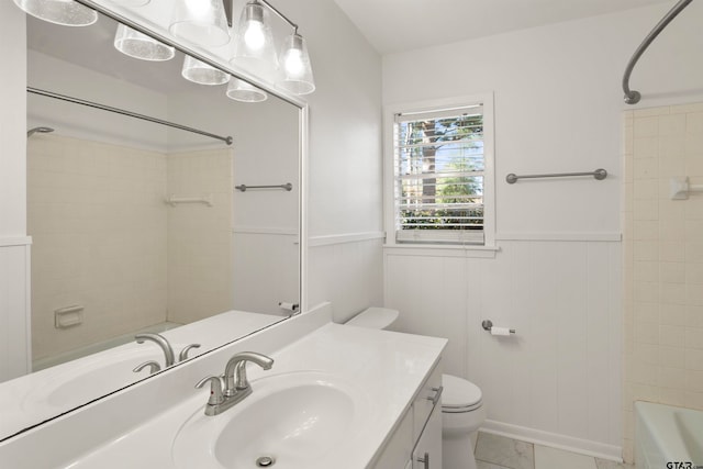 bathroom featuring wainscoting, vanity, and toilet