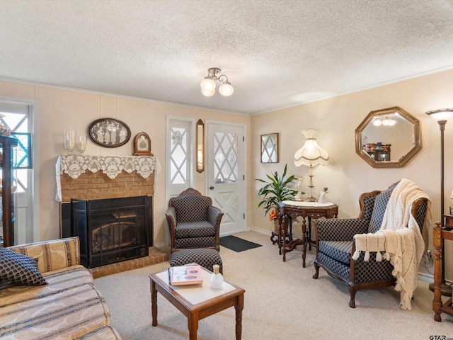 carpeted living room featuring a fireplace, ornamental molding, and a textured ceiling