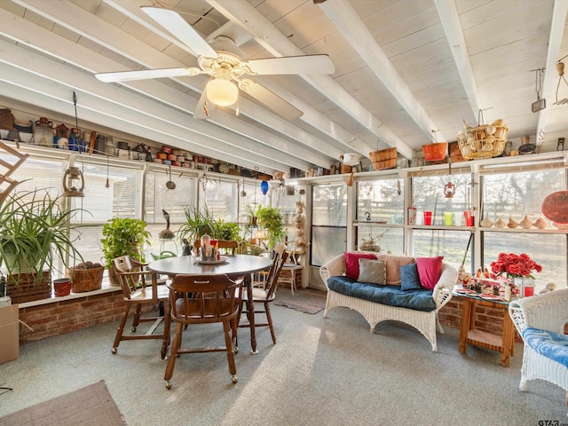 sunroom / solarium with ceiling fan and lofted ceiling with beams