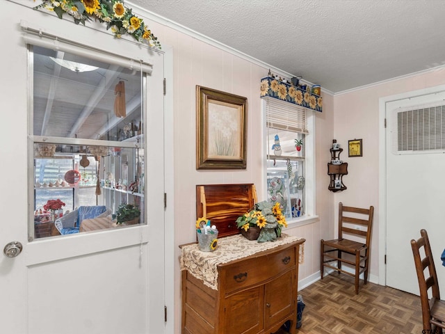 doorway to outside with crown molding, a textured ceiling, and dark parquet floors