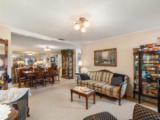 carpeted living room with a textured ceiling and a notable chandelier