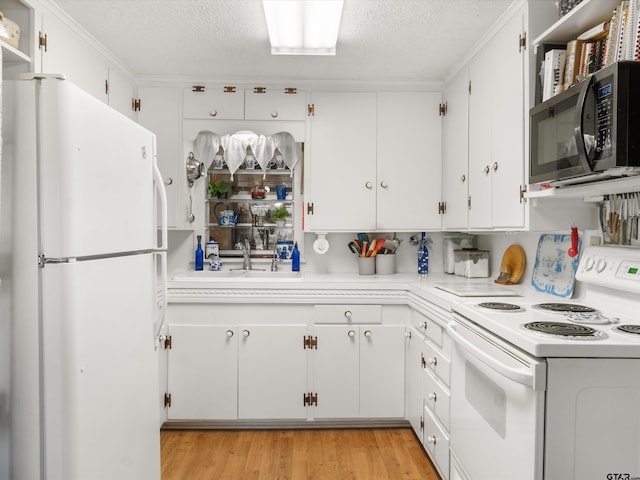 kitchen featuring light hardwood / wood-style flooring, sink, white appliances, a textured ceiling, and white cabinets