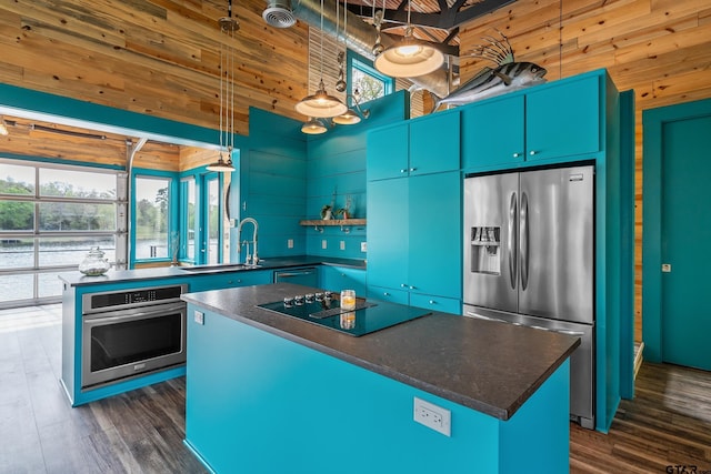 kitchen featuring dark countertops, appliances with stainless steel finishes, and a healthy amount of sunlight