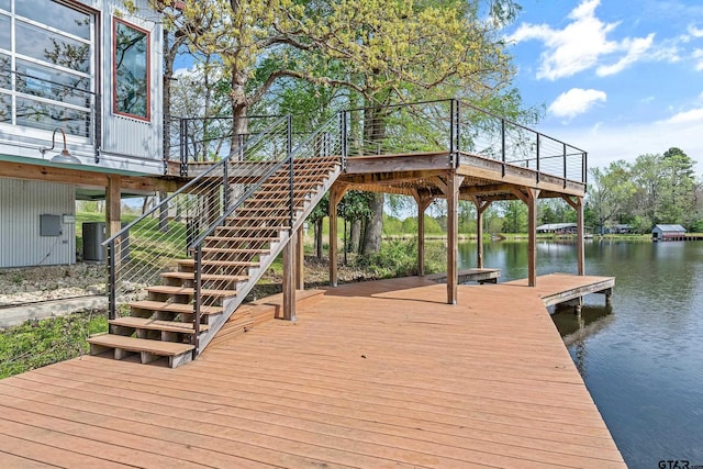 dock area with a water view, stairway, and central AC unit
