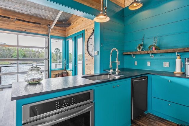 kitchen with a healthy amount of sunlight, a sink, oven, and dark countertops