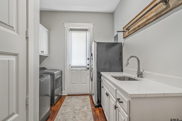 14611 Twin Pines Ln, Lindale, TX 75771 - washroom featuring independent washer and dryer, cabinet space, and dark wood finished floors