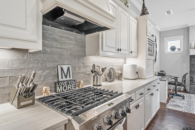 14611 Twin Pines Ln, Lindale, TX 75771 - kitchen with stainless steel gas range oven, custom range hood, white cabinets, ornamental molding, and light countertops