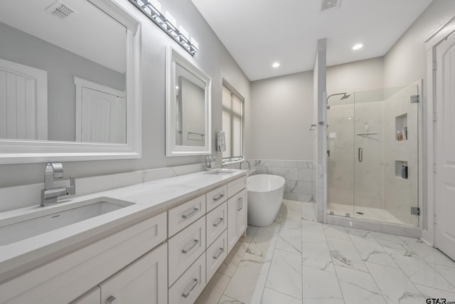 14611 Twin Pines Ln, Lindale, TX 75771 - bathroom featuring a shower stall, a freestanding tub, double vanity, marble finish floors, and recessed lighting