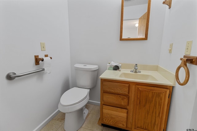 bathroom featuring toilet, vanity, and tile patterned floors