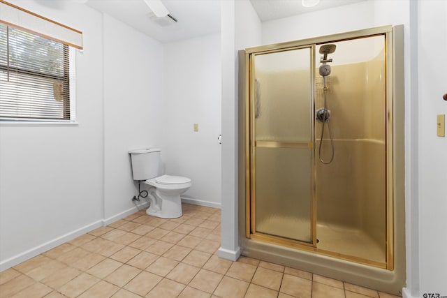 bathroom featuring tile patterned flooring, an enclosed shower, and toilet