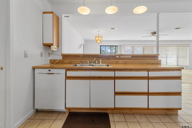 kitchen with white dishwasher, pendant lighting, white cabinets, and sink