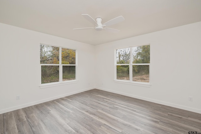 empty room with light hardwood / wood-style flooring and ceiling fan