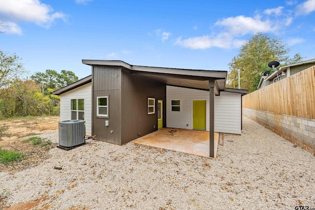 rear view of property with a patio area and central AC unit