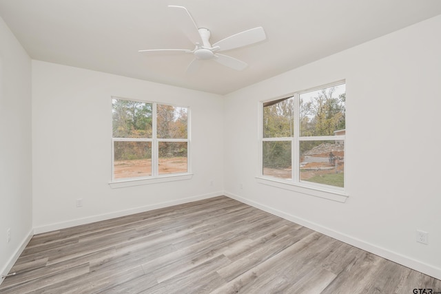 unfurnished room with ceiling fan and light wood-type flooring