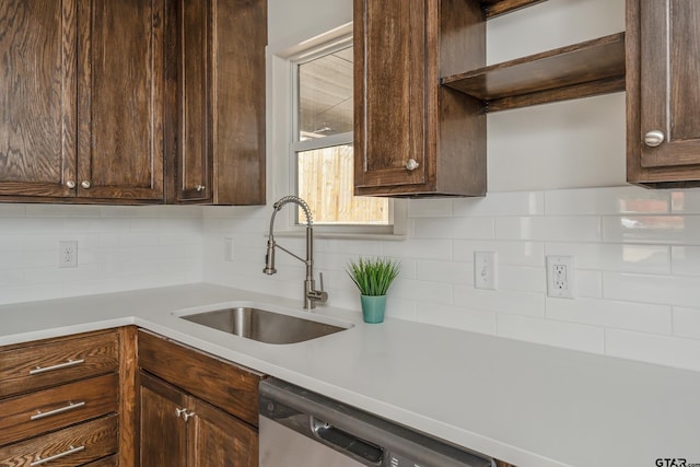 kitchen featuring decorative backsplash, dishwasher, sink, and dark brown cabinetry