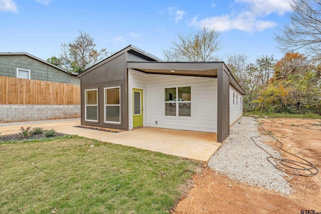 back of house featuring a yard and a patio