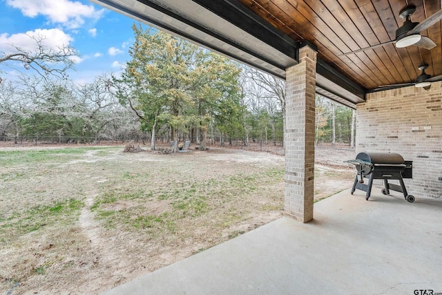 view of yard featuring a patio area, fence, and a ceiling fan