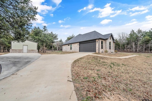 view of home's exterior featuring a garage, concrete driveway, brick siding, and a shingled roof