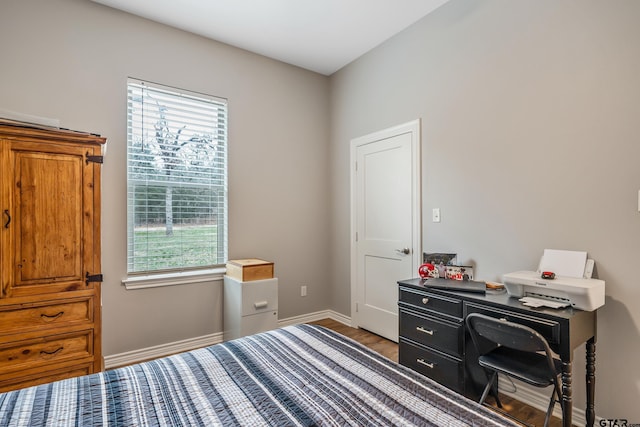 bedroom featuring baseboards and wood finished floors