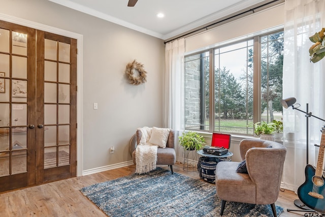 sitting room with recessed lighting, wood finished floors, baseboards, french doors, and ornamental molding