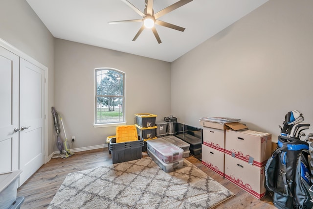 game room featuring light wood-style flooring, baseboards, and a ceiling fan